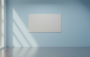 Blank canvas on light blue wall, sunlit room, empty interior, presentation mock-up