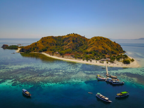 Aerial view of Tourist boats moored off the coast of Kelor island, Komodo National Park, East Nusa Tenggara, Indonesia