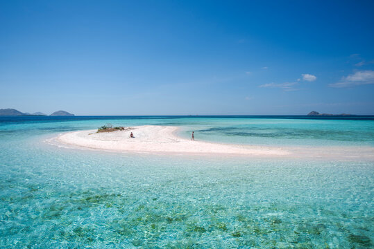 Two people on a sandbar island in the Indian Ocean, Taka Makassar, Komodo National Park, East Nusa Tenggara, Indonesia