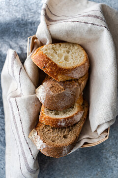 Close-up overhead view of Freshly sliced  brown and white sourdough bread in a bread basket