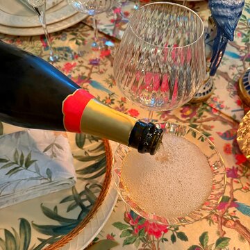 Close-up of champagne being poured into a champagne coupe on a dinner table