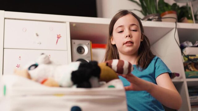 Chilchild, casual, caucasian, chore, chores, clean, clean up, cute, daughter, day, duty, education, toy, apartment, at home, bage, basket, beautifud cleans up her toys. Little girl tydies up her room.