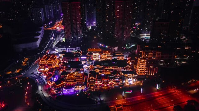 Chongqing Ancient Town illuminated at night with traffic delays on the main road