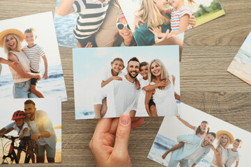 Woman with different photos at wooden table, top view