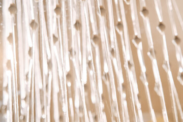 Abstract texture of water jets from the shower in close-up.