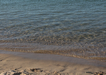 Summer vacation wavy, calm, deep blue sky, mountains, thin white clouds not visible, clear weather. boat, dinghy, rowboat far away. yellow shiny brown sea sand on shore beach. Balıkesir, Sarimsakli