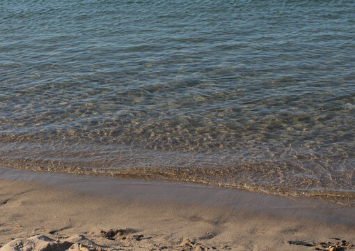 Summer vacation wavy, calm, deep blue sky, mountains, thin white clouds not visible, clear weather. boat, dinghy, rowboat far away. yellow shiny brown sea sand on shore beach. Balıkesir, Sarimsakli