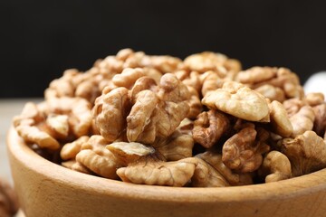 Peeled walnuts in bowl on table, closeup