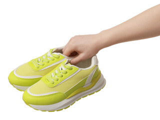 Woman with neon lime sneakers on white background, closeup
