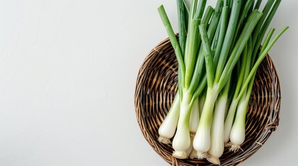 a basket filled with fresh leek with empty space and white background