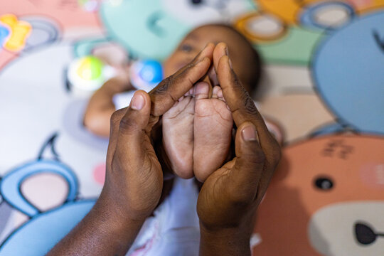 A little girl doing tummy time, a little girl. Newborn premature baby. Tummy time is fun time. African baby, African girl, black baby, Brazilian baby. Rio de Janeiro, Brazil.