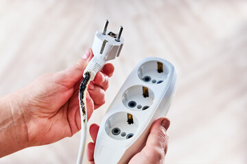Scorched cable disconnected from damaged extension socket.