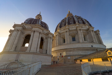 Two domed structures of St. Peter's Basilica, with the main dome on the right and a smaller,...