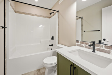 A bathroom with a green cabinet and a white sink