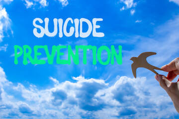 Suicide prevention symbol. Concept words Suicide prevention on beautiful blue sky. Psychologist...