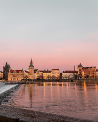 Sunset colors in Prague Historical Gothic Medieval castle, St. Vitus Cathedral, Charles Bridge and river Vltava boat cruise, astronomical clock, Unesco city tourism, golden hour and water reflection