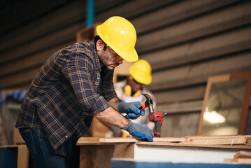 Focused craftsman in an industrial workshop, demonstrating woodworking techniques and handcrafting...