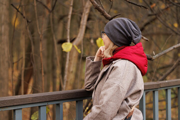 Contemplative moment in autumn woods, a woman enjoys natures beauty on a serene day