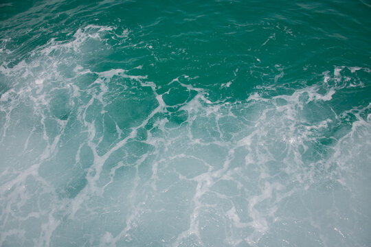 abstract background with waves on the blue sea as seen behind a boat