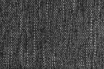 Black Jacquard fabric with large loose woven, coarse weave texture upholstery cloth. Textile background, furniture textile material, wallpaper, backdrop. Cloth structure close up, macro.