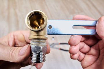 Before connecting stainless steel threaded nipple to brass pipe fitting for secure seal, plumbing...
