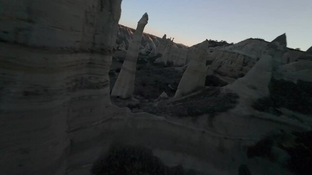 FPV Drone Circling and Flying Between Chimney Like Spires and Phallic Rock Formations in Love Valley