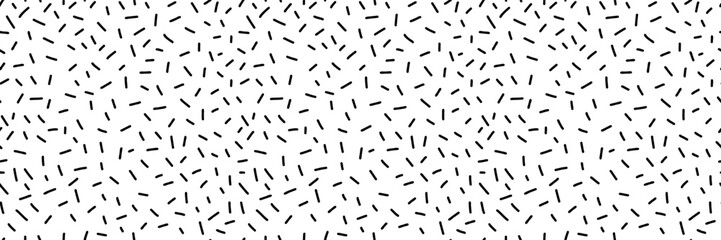 Small dash seamless pattern. Abstract Memphis style background, retro confetti black and white texture, simple geometric shapes, playful design. Perfect for prints, and textiles. Vector illustration