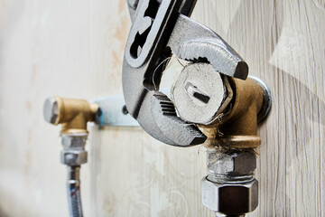 Tightening pipe plugs with an adjustable pliers wrench ensures secure seal on plumbing system...
