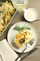 Tasty pasta casserole with cheese and broccoli served on wooden table, flat lay