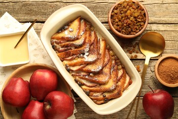 Flat lay composition with tasty bread pudding on wooden table