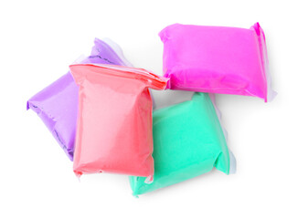Different colorful play dough in packages isolated on white, top view