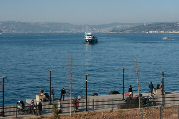 Scenic view of a ferry approaching the shore on a sunny day in Istanbul, turkey