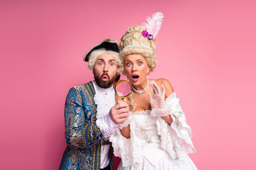 Two People in Royal Vintage Costumes Exuding Surprise and Elegance