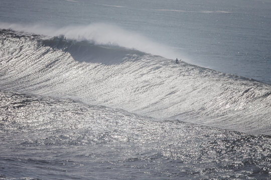 Surfer at Mavericks, California: Calm and Focused Amidst Giant Waves.