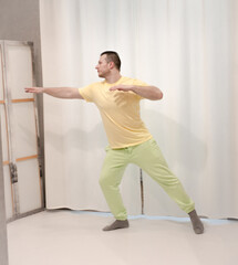 Male choreography in motion in the studio. Young man dancing in a dance studio