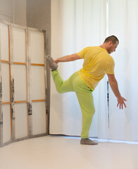Male choreography in motion in the studio. Young man dancing in a dance studio