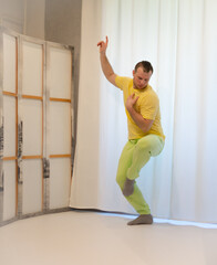 Male choreography in motion in the studio. Young man dancing in a dance studio