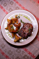 Beautiful restaurant dish golden potatoes and juicy meat, beautiful food photo