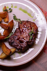 Beautiful restaurant dish golden potatoes and juicy meat, beautiful food photo