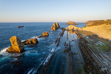 Dramatic view of Playa de la Arnia, Cantabria, Spain. Arnia Beach, Asturias at sunset. Amazing landscape, lines, abstract shapes beautiful colors.