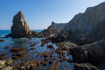 Dramatic view of Playa de la Arnia, Cantabria, Spain. Arnia Beach, Asturias at sunset. Amazing landscape, lines, abstract shapes beautiful colors.