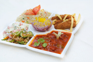 Chicken Shashlik with red sauce in a platter with rice.