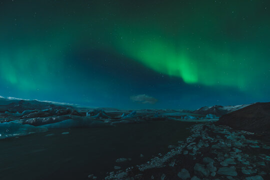 Northern Lights Over a Frozen Glacial Landscape