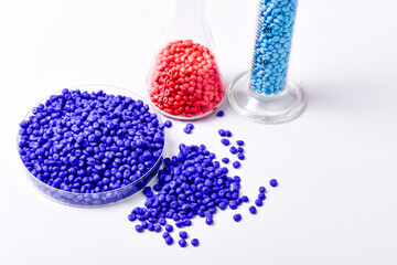 Blue and soft pink masterbatch granules on white background, color pigment carrier polymer in...