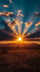 Sunrise over mountains with rays of light spreading across the sky