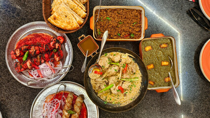 Desi Cuisines, Chicken Karahi, Palak Paneer, Mutton Qeema, Chicken Kebab, Chicken Tikka, Roghni Naan top angle 