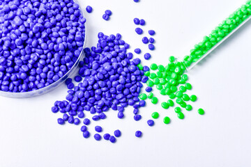 Blue and green masterbatch granules on white background, color pigment carrier polymer in plastic...