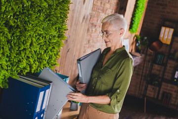 Photo of lovely nice lady admin dressed shirt hold folder work modern office workplace workstation...