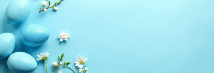Blue Easter eggs with white flowers on light blue pastel background
