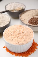 Different types of flour on white table, closeup
